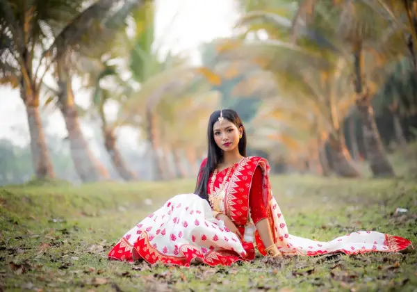 A young Bangladeshi woman in a red and white sari
