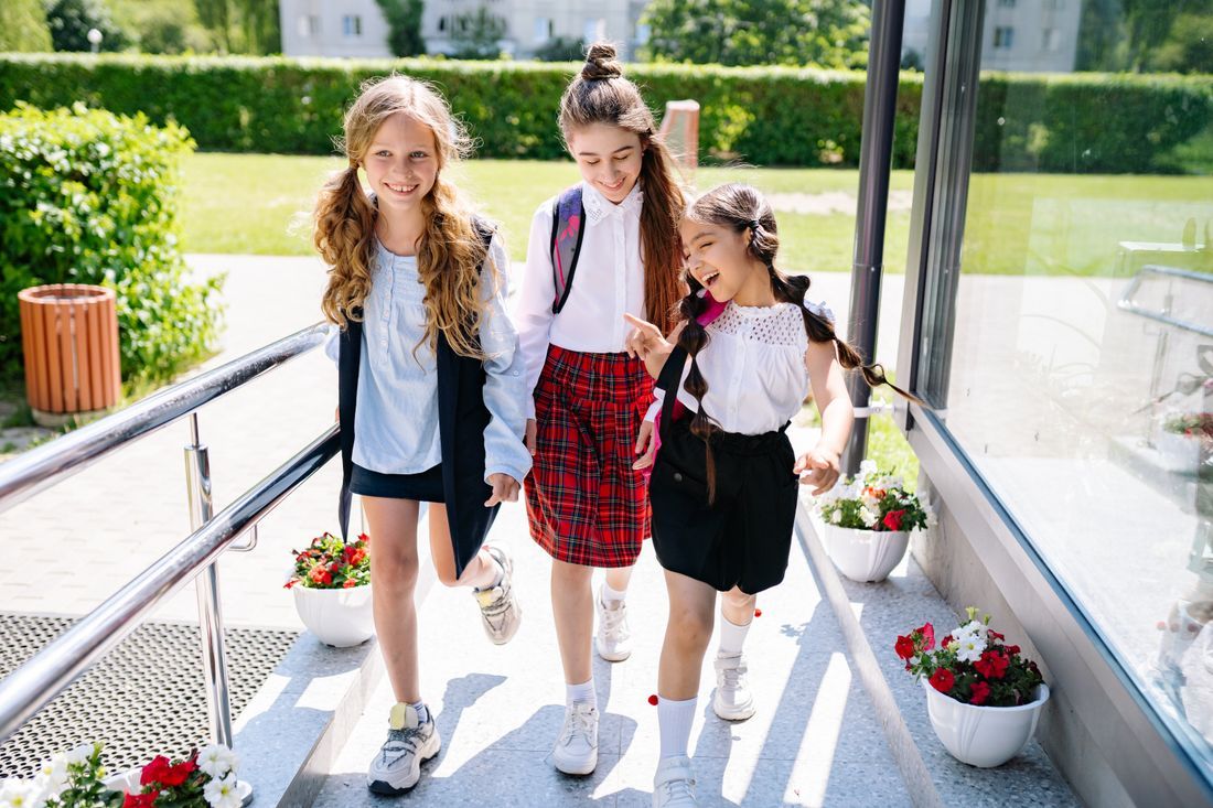 Three middle school girls walking and laughing together