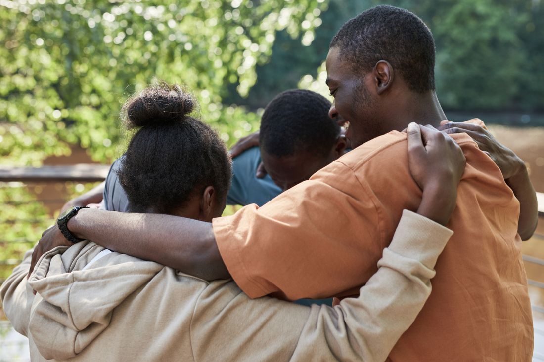 A family holding one another close in a reunion embrace