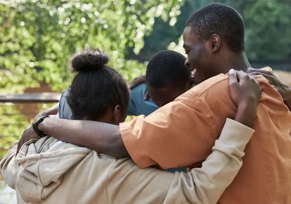 A family holding one another close in a reunion embrace