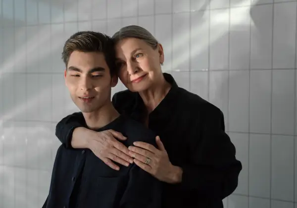 An older woman embracing her grown son tenderly