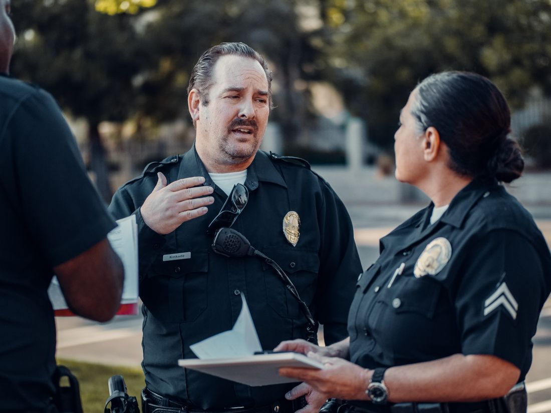 Two officers, a man and a woman, talking through a hard moment