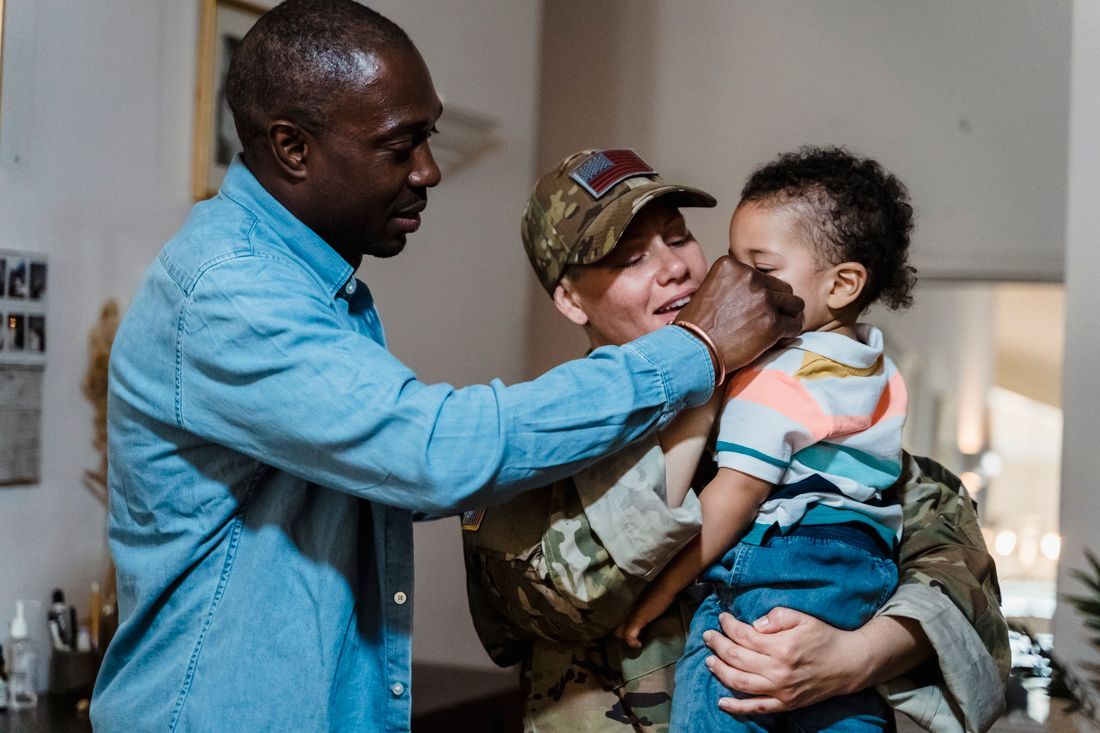 A returning soldier reunited with her husband and child