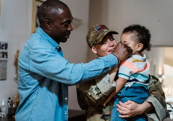 A returning soldier reunited with her husband and child