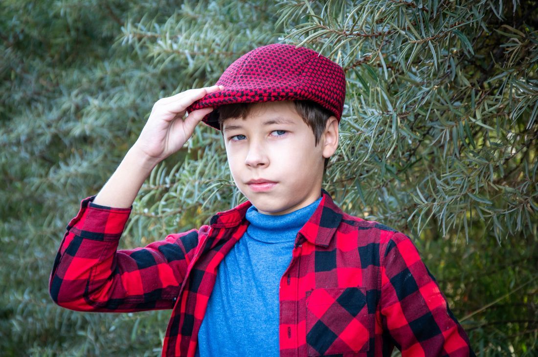 A thoughtful teenage boy outdoors