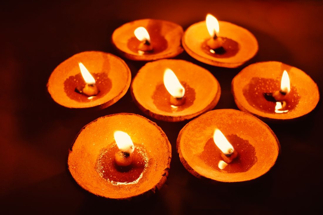 Clay diya lamps glowing in the dark