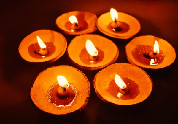 Clay diya lamps glowing in the dark