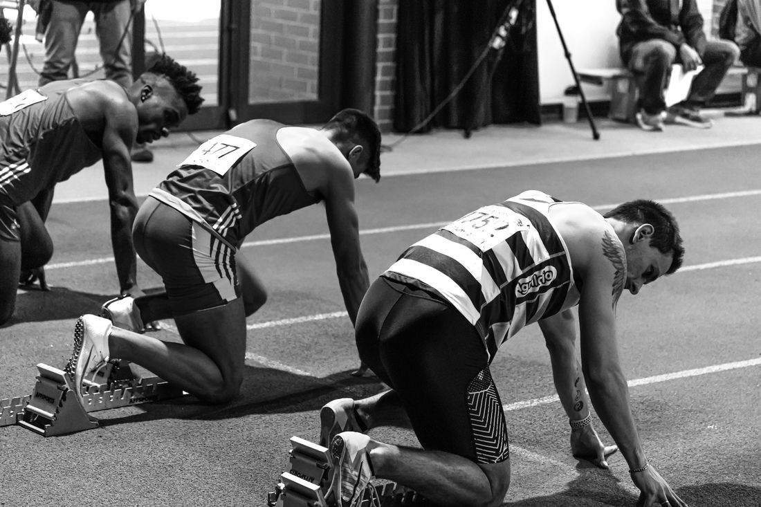 Sprinters set in the starting blocks, focused