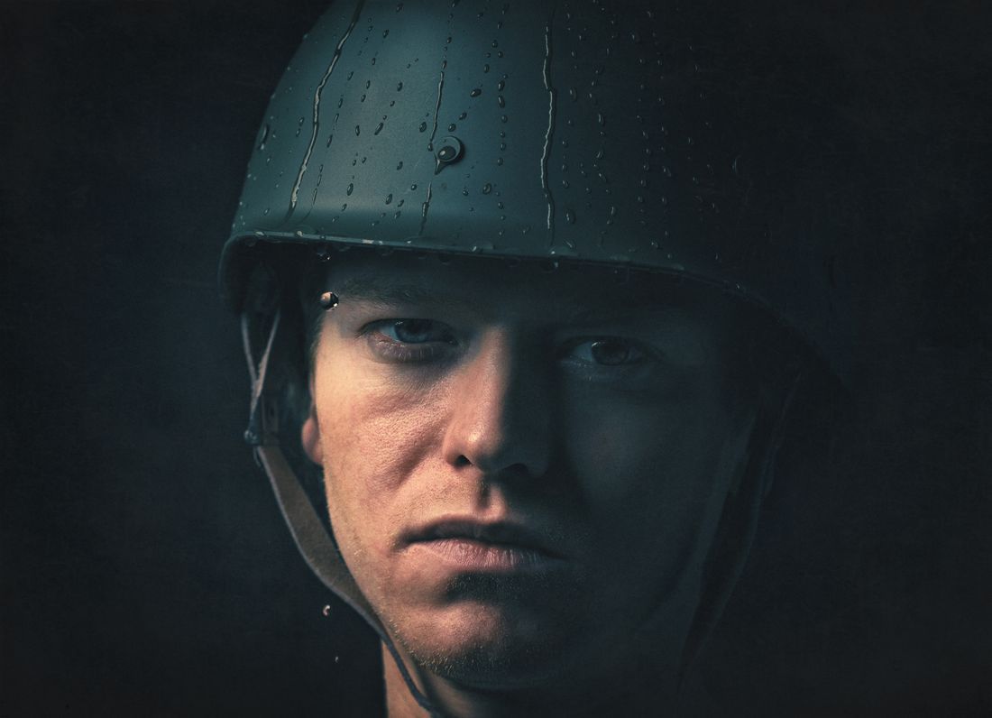 A soldier's resolute face, carrying what most will never see