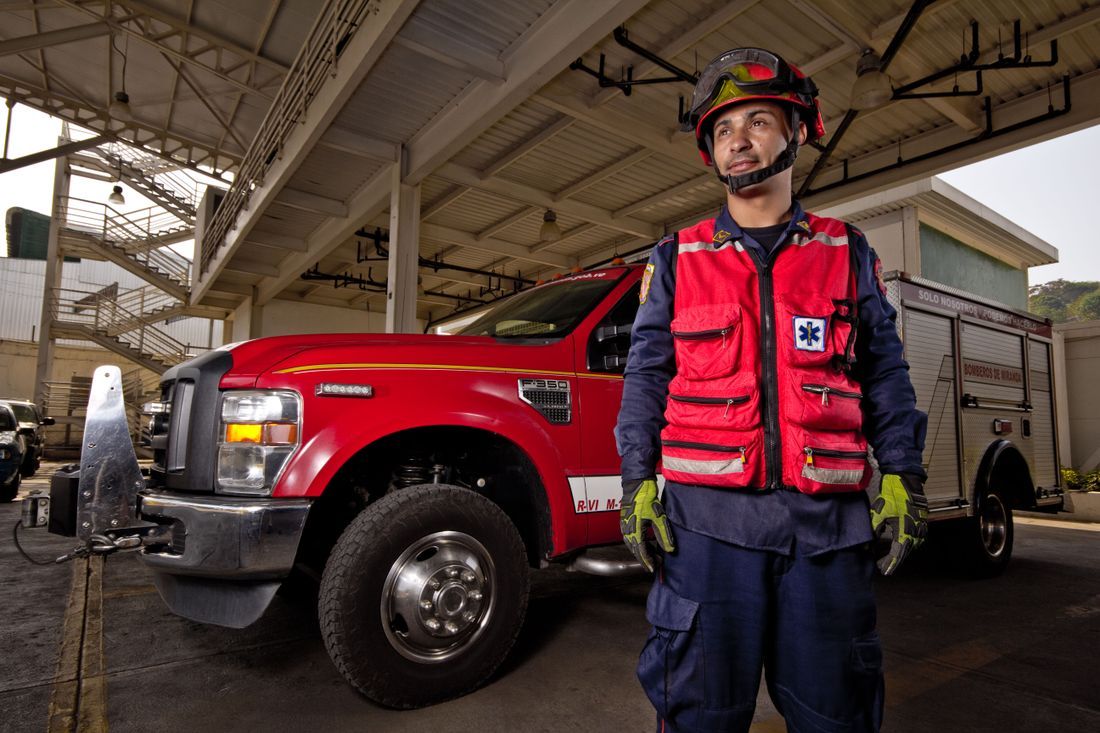An emergency responder standing ready beside the rescue truck