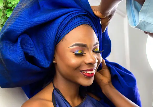 A Nigerian woman in a traditional gele headwrap