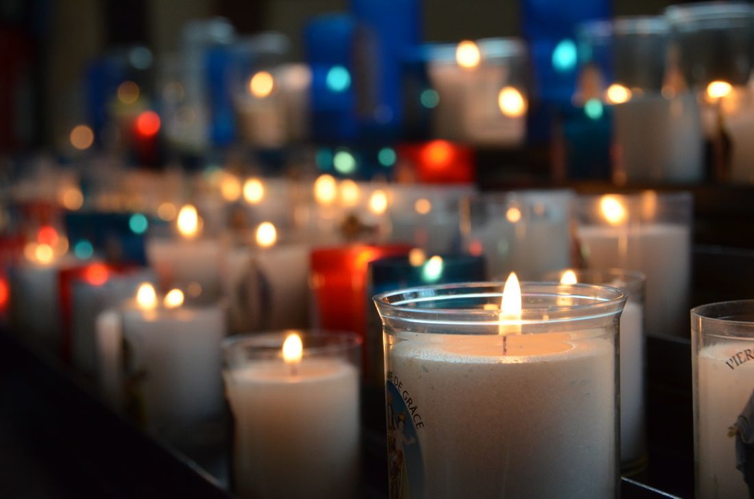 Votive prayer candles in colored glass