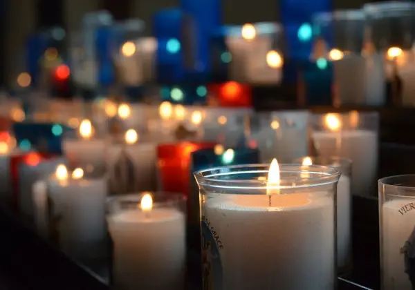 Votive prayer candles in colored glass