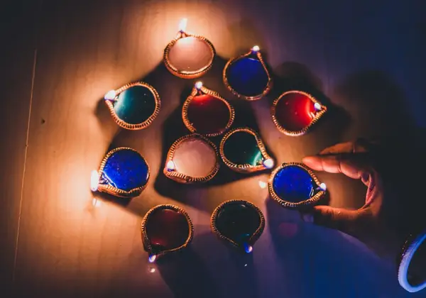 Colorful oil lamps being lit in devotion