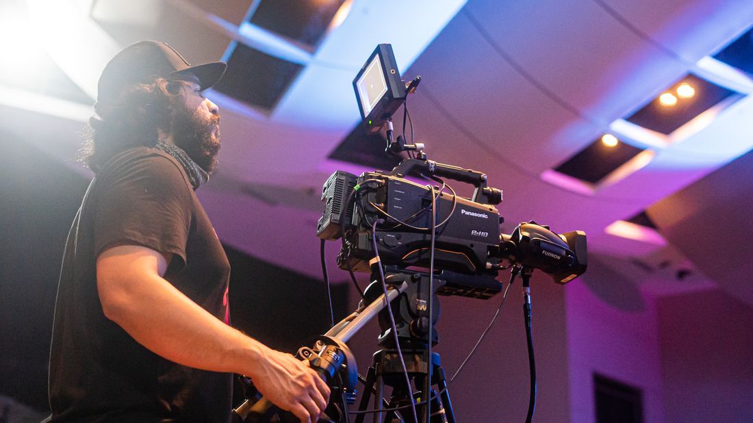 A church video operator running a broadcast camera during a service