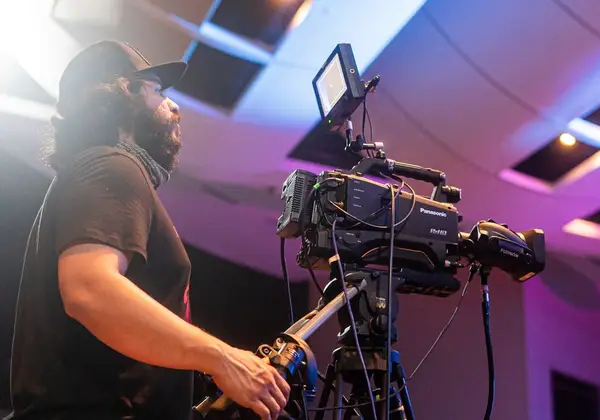 A church video operator running a broadcast camera during a service