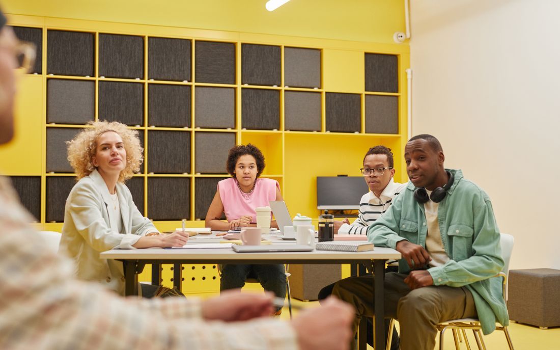 A diverse church staff team in a planning meeting around a table