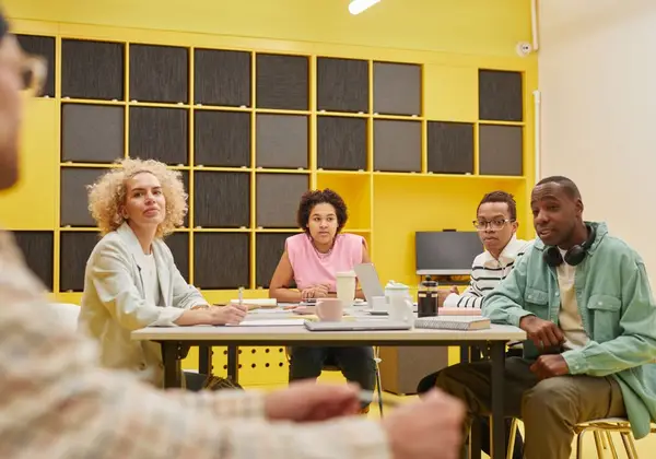 A diverse church staff team in a planning meeting around a table