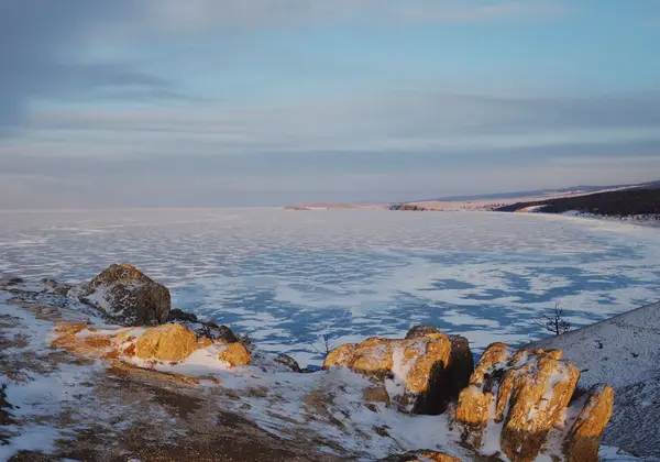 Frozen Lake Baikal at sunset