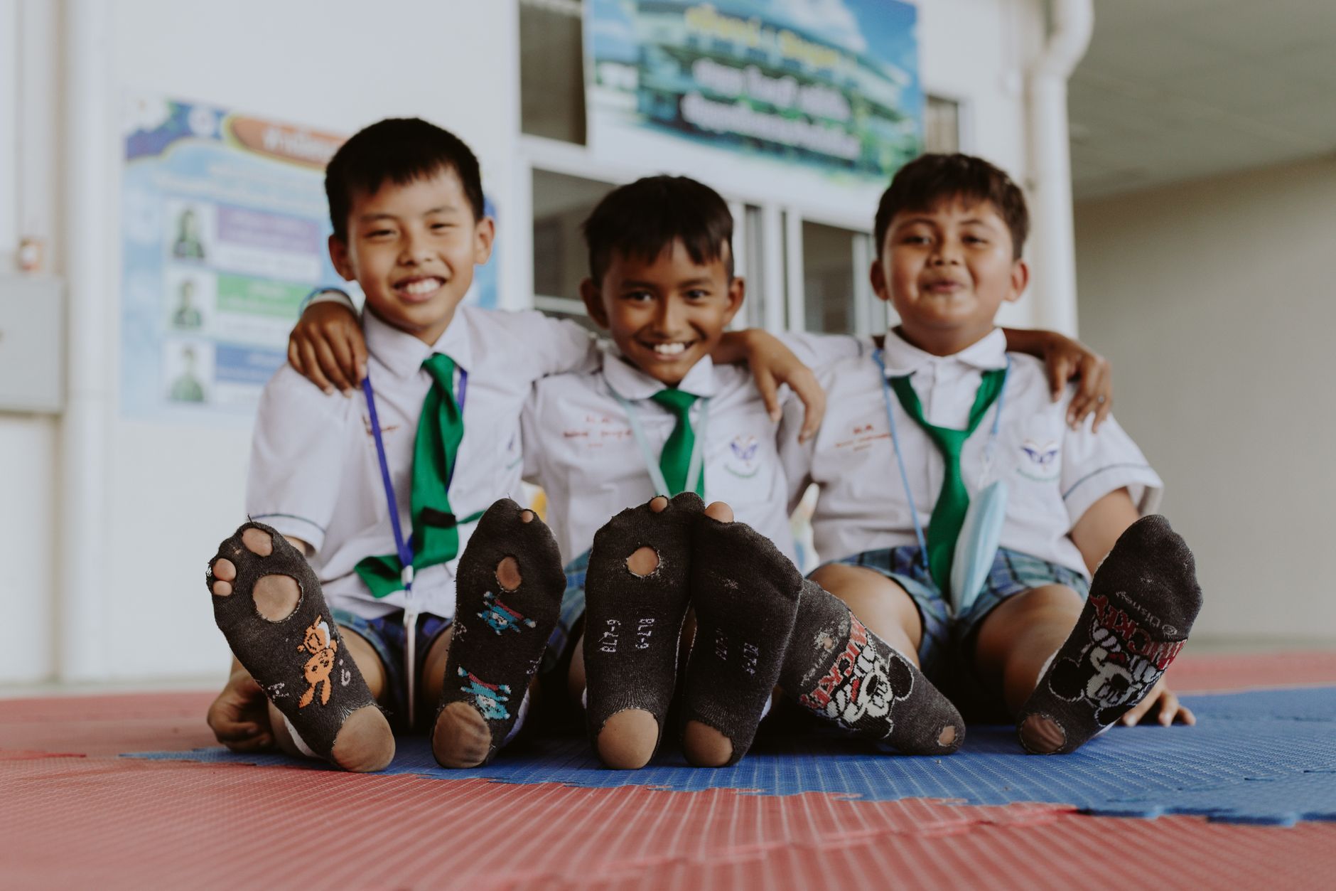Three Thai schoolboys smiling together