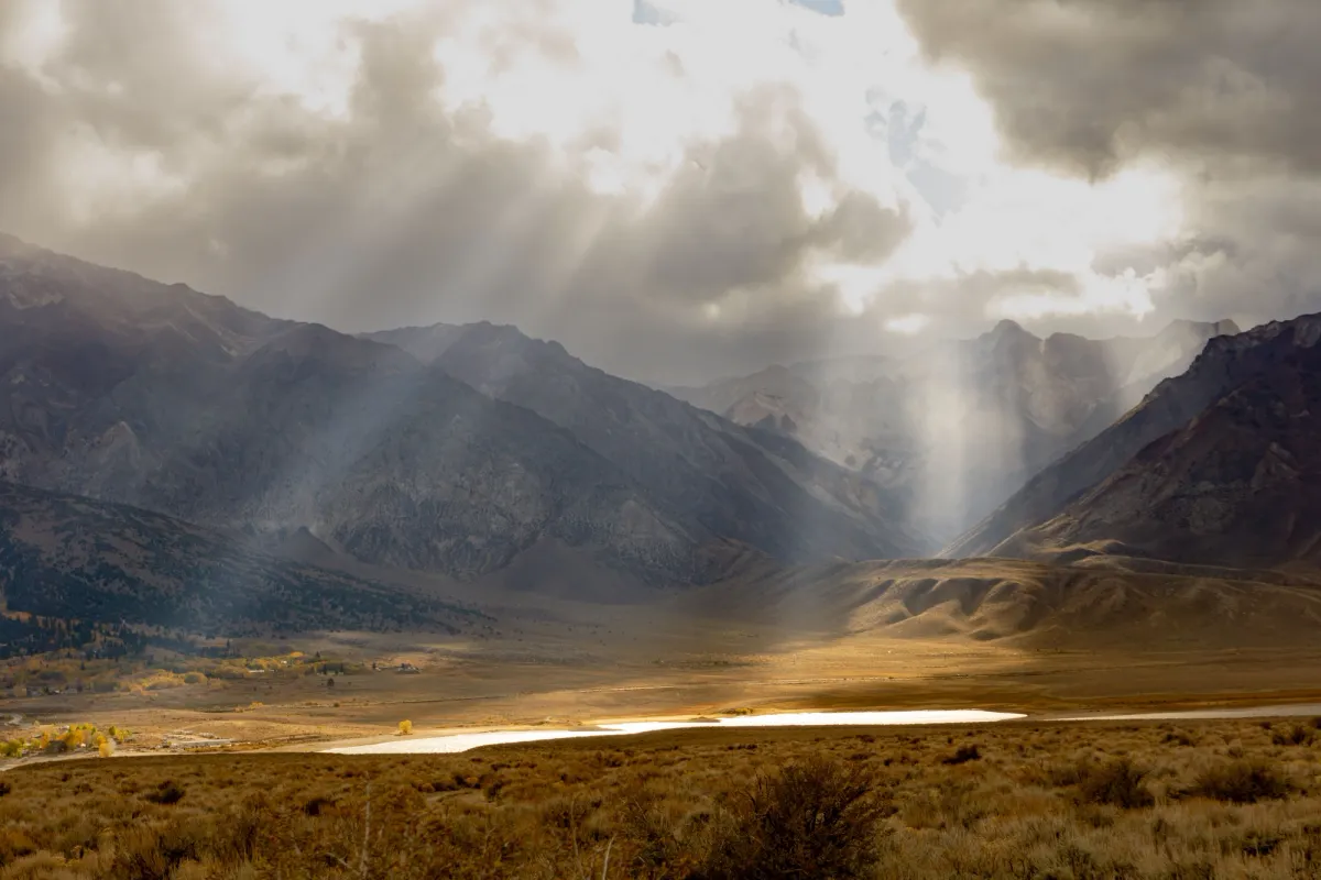 Dawn breaking over mountains — a picture of the Father's vision rising over His beloved sons and daughters.