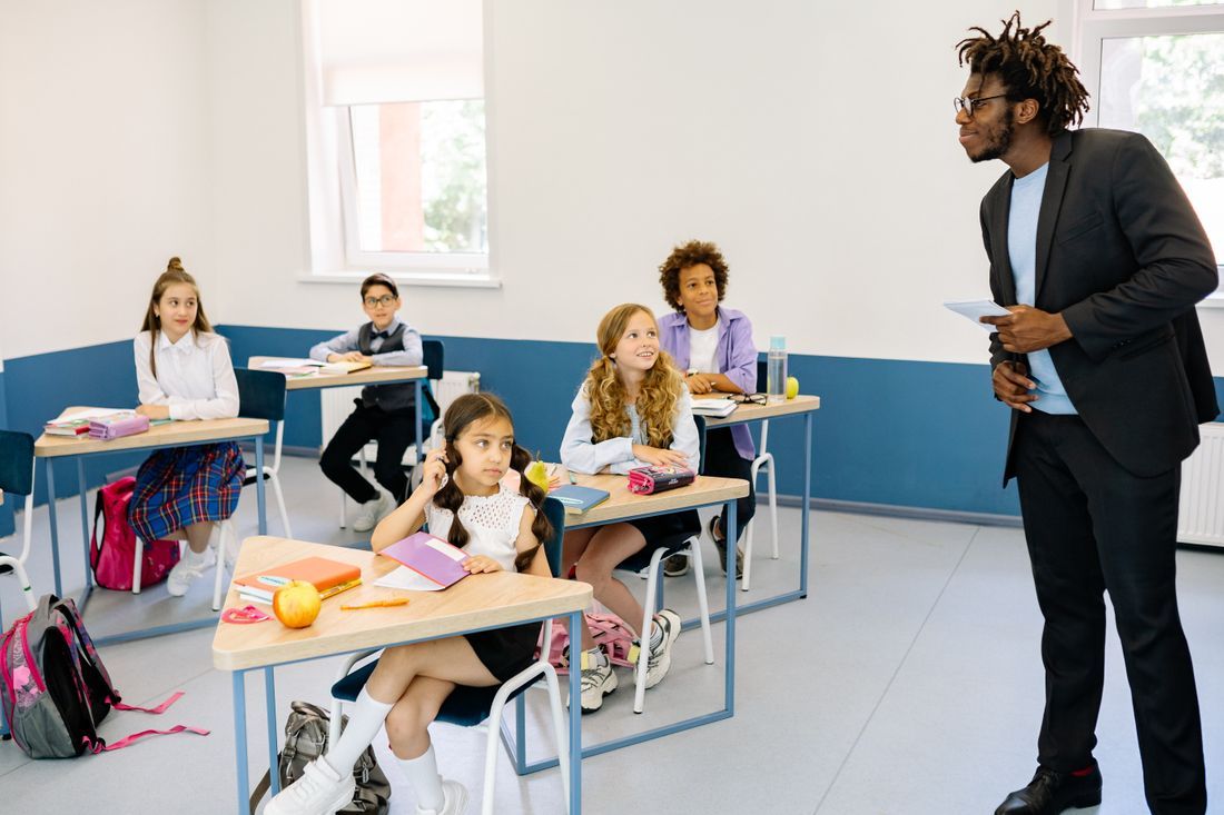 A teacher engaging a diverse classroom of attentive students
