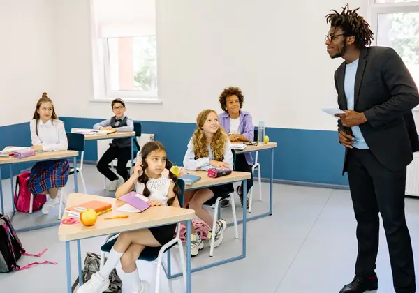 A teacher engaging a diverse classroom of attentive students