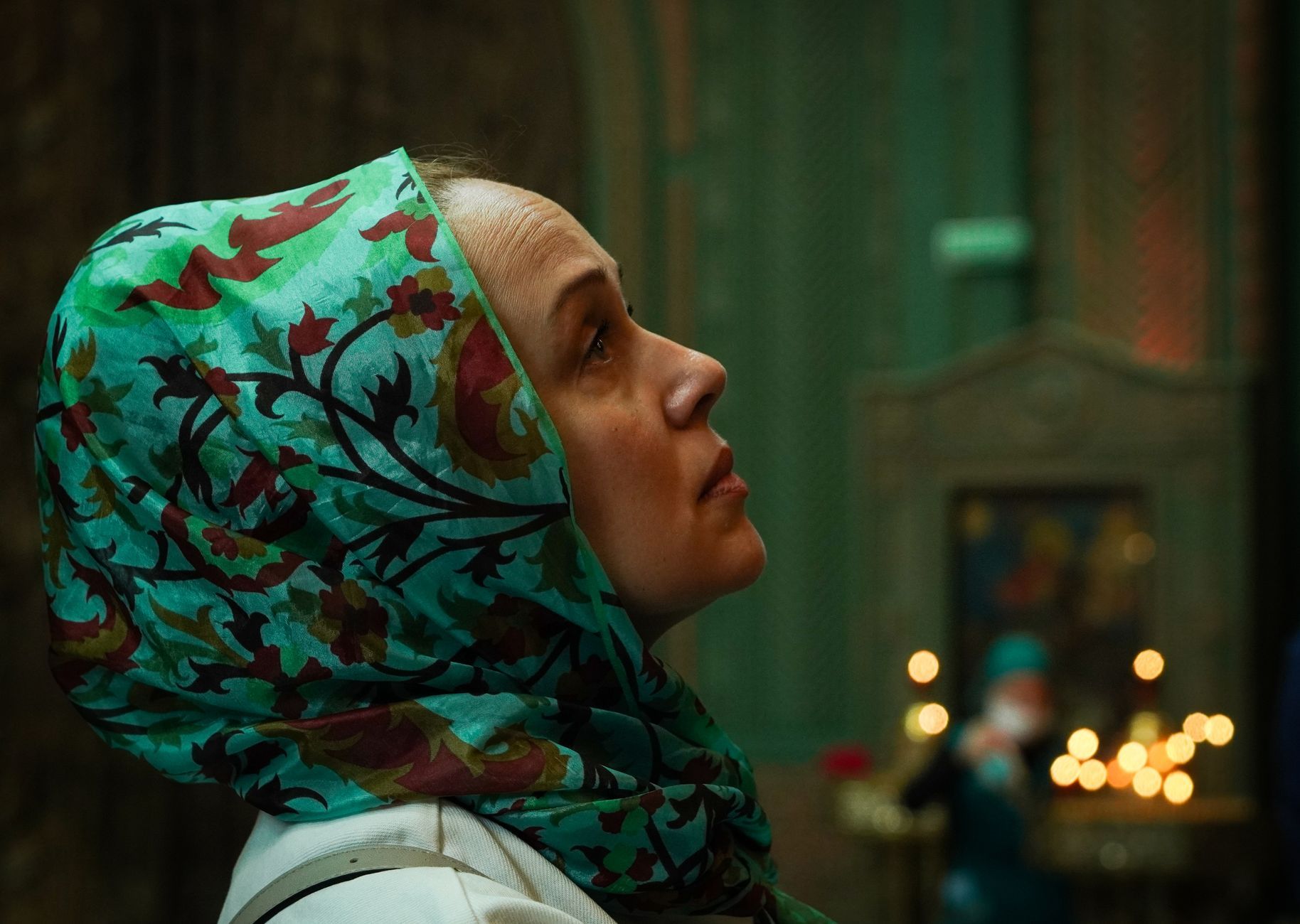 A Russian woman praying in an Orthodox church