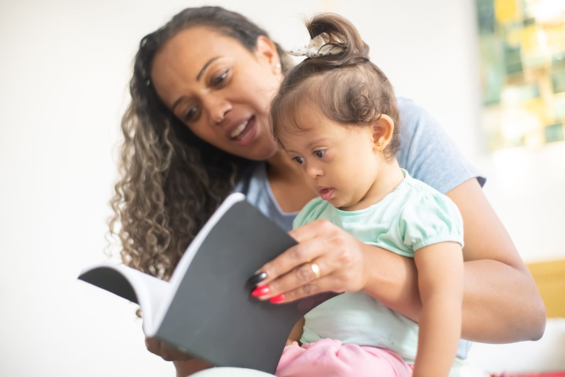 A mother reading to her young child
