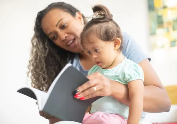 A mother reading to her young child