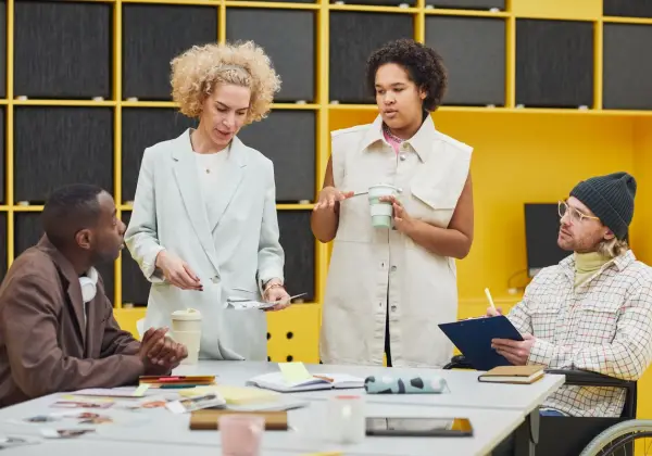 An inclusive team meeting, including a colleague using a wheelchair