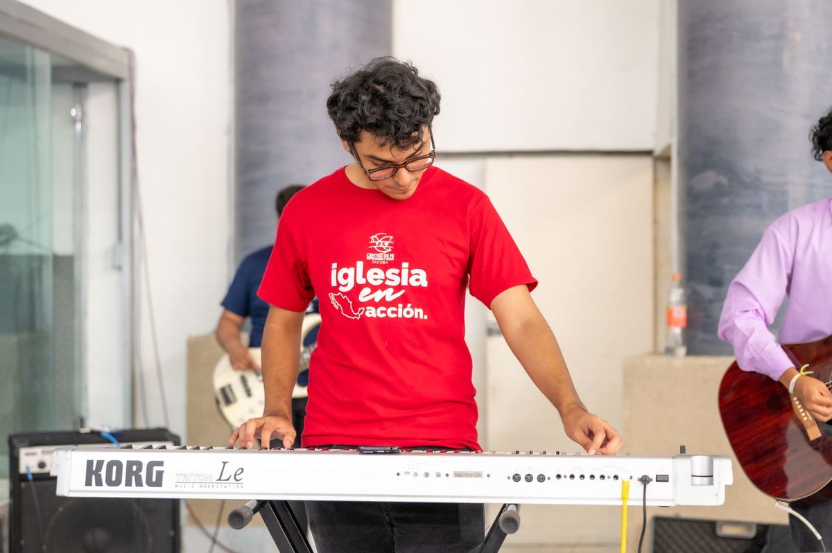 A young musician playing keyboard during a worship set