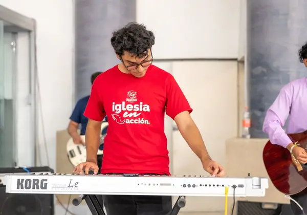 A young musician playing keyboard during a worship set