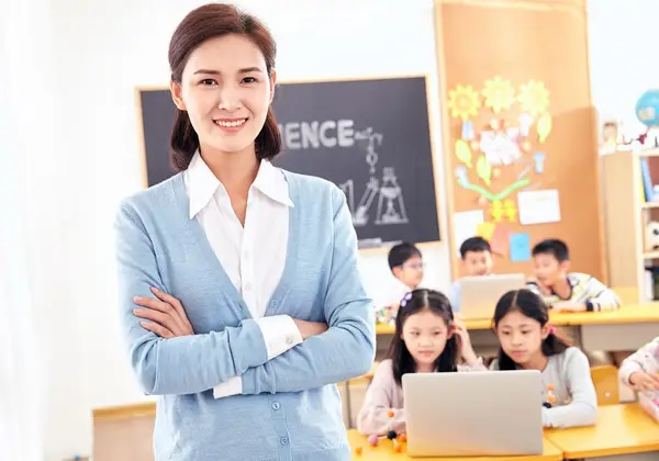 A smiling children's teacher in a bright classroom
