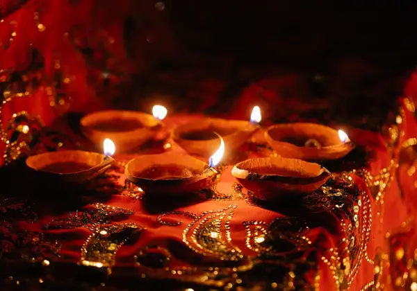 Lit diya oil lamps glowing in the dark