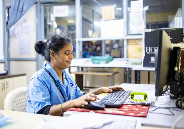 A church office worker at a computer keeping the ministry running