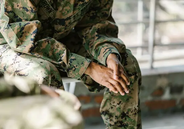 A Marine's clasped hands as he sits in reflection