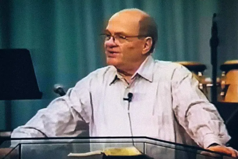 Jack Winter teaching from a podium — the forerunner of the modern Father-heart movement, who received the revelation of our Father's love in 1977 and carried it across more than thirty nations until his death in 2002.