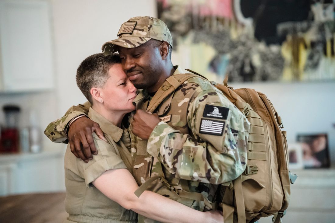 A service member embracing a loved one on coming home