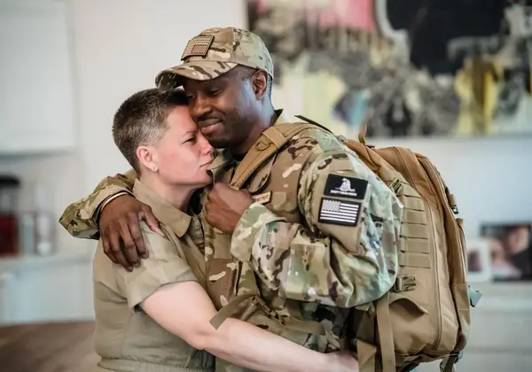 A service member embracing a loved one on coming home