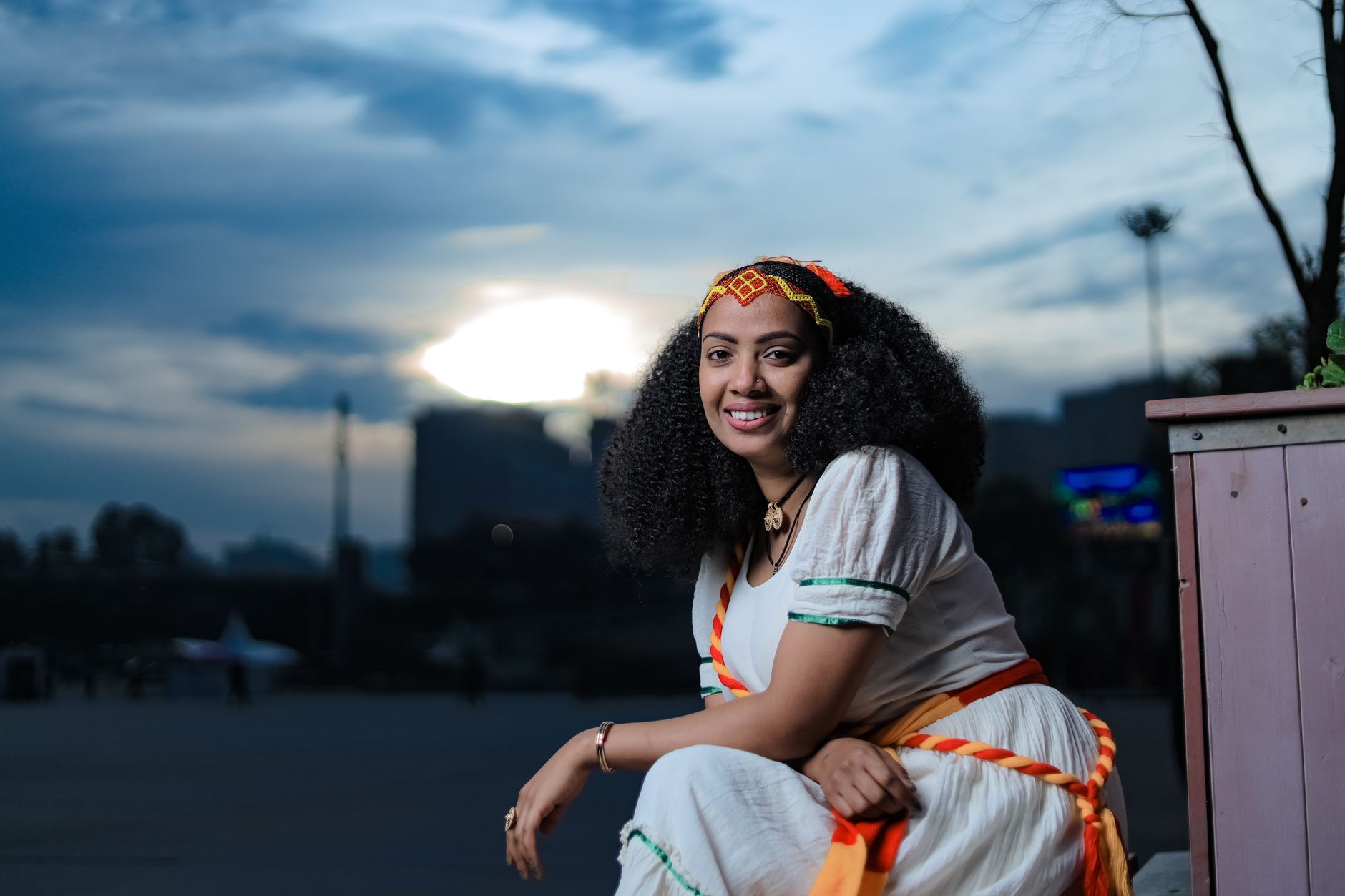 A smiling Ethiopian woman in traditional attire