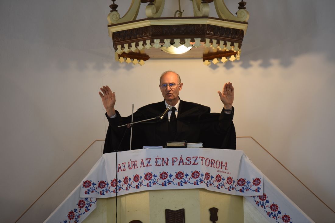 A pastor preaching from an ornate pulpit