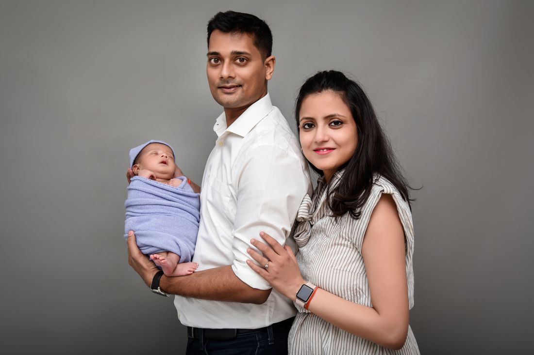 New parents holding their newborn close