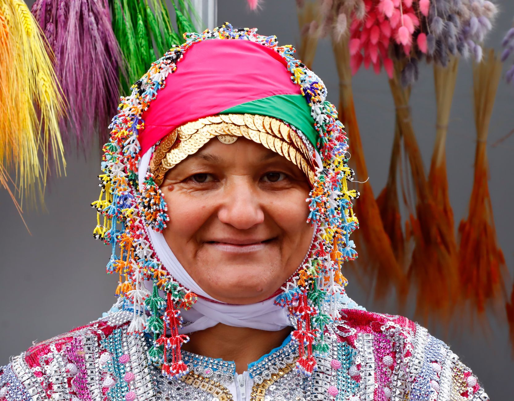 A smiling Turkish woman in traditional dress