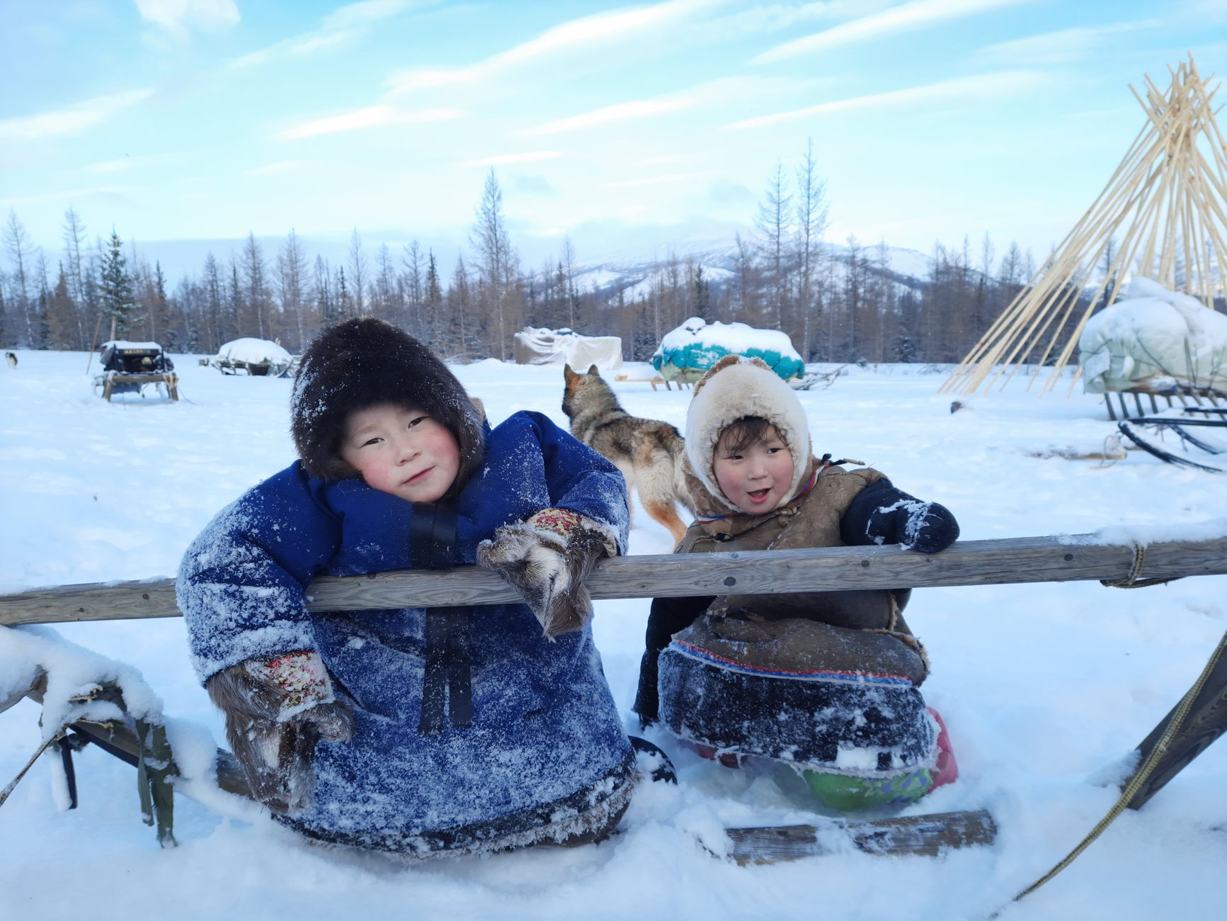 Two children bundled against the snow in the Russian north