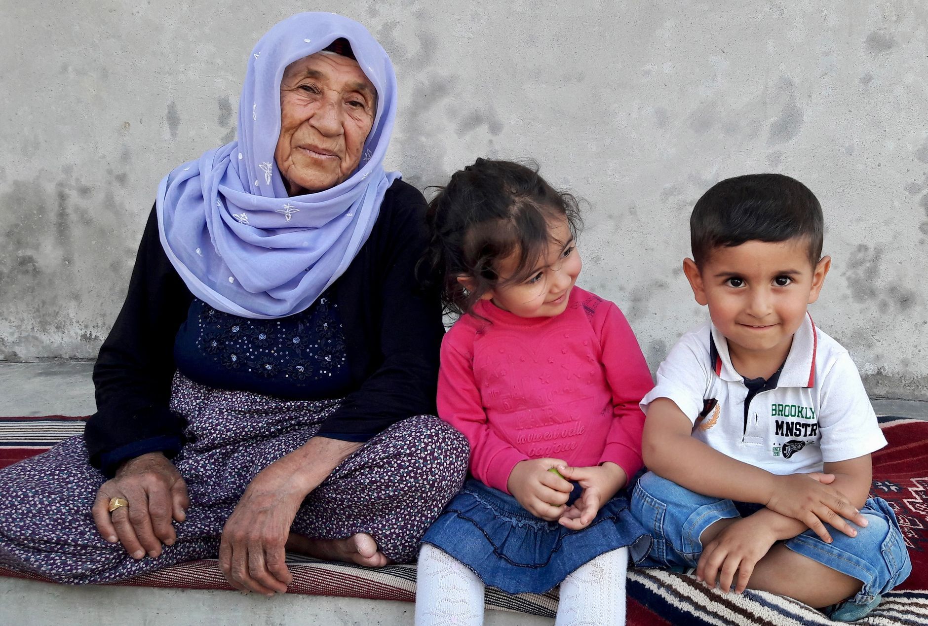 A Turkish grandmother with her two grandchildren