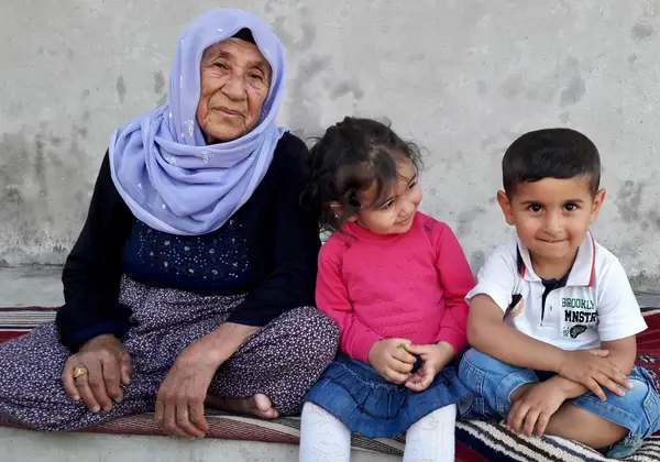 A Turkish grandmother with her two grandchildren