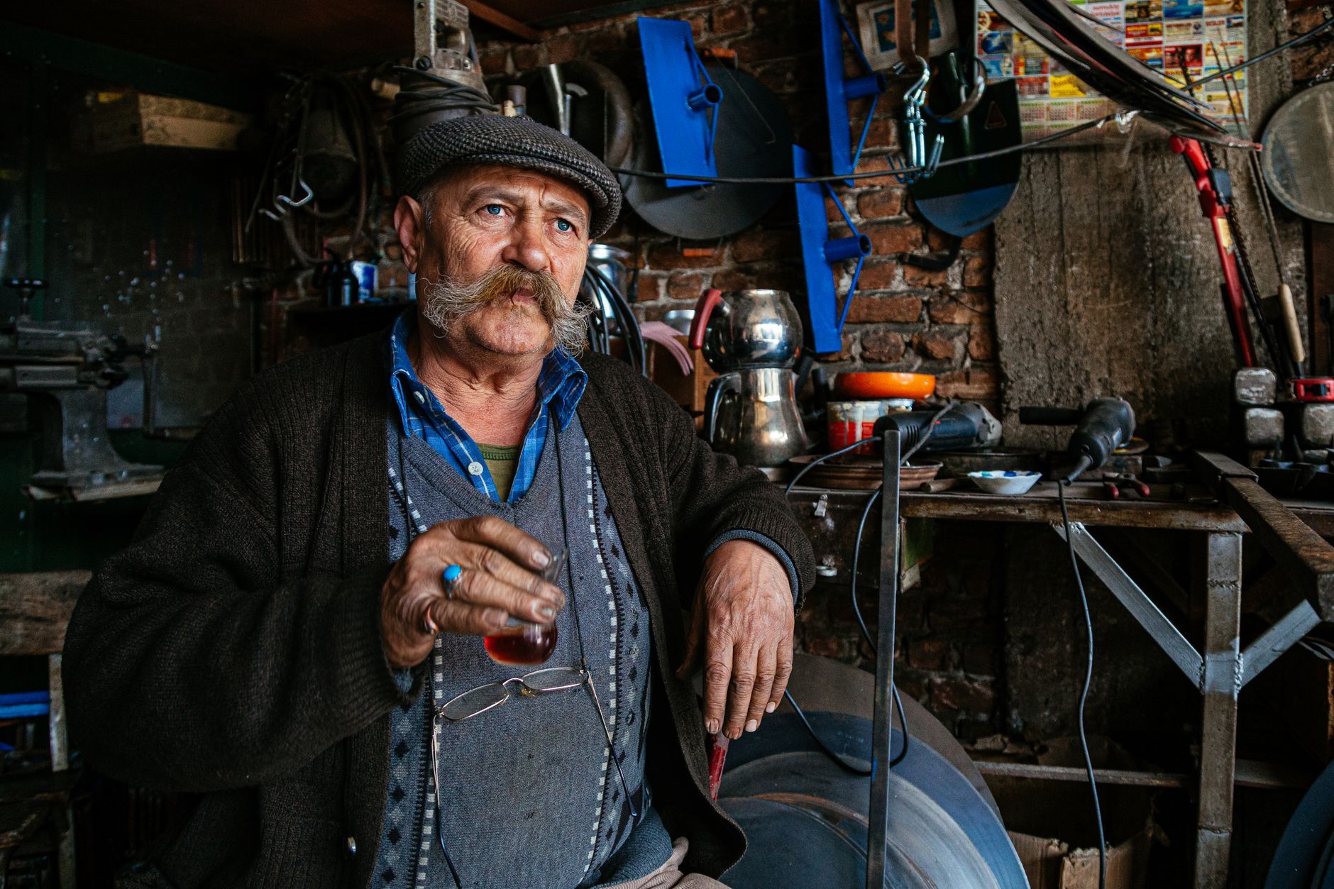 A Turkish craftsman with tea in his workshop