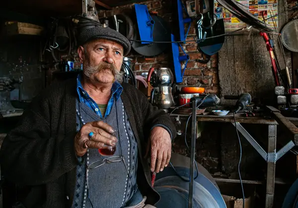 A Turkish craftsman with tea in his workshop