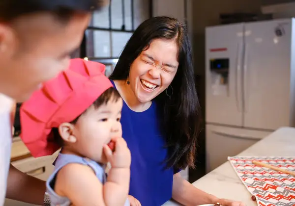 A Korean family laughing together at home